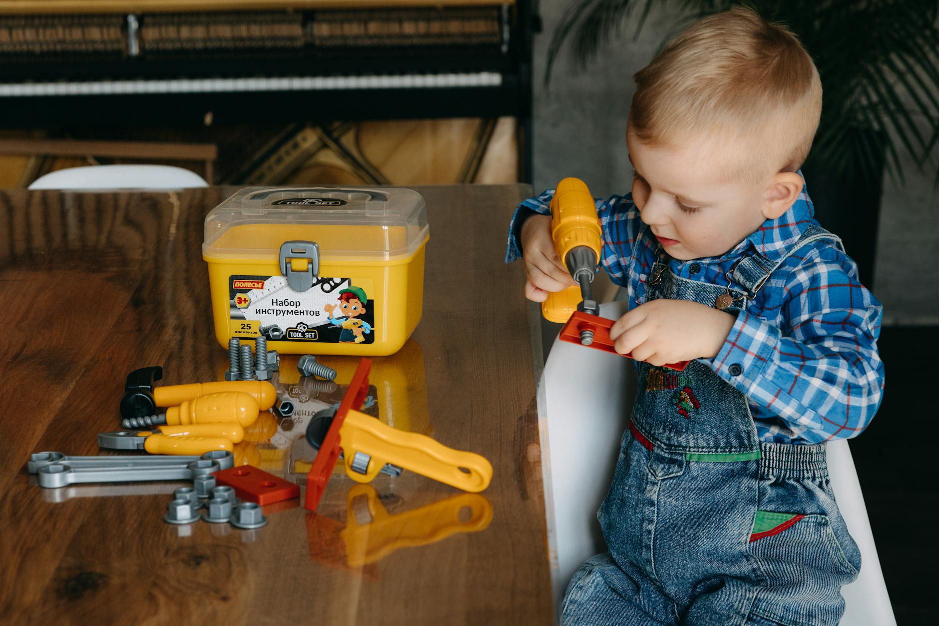 a young boy is playing with a tool set