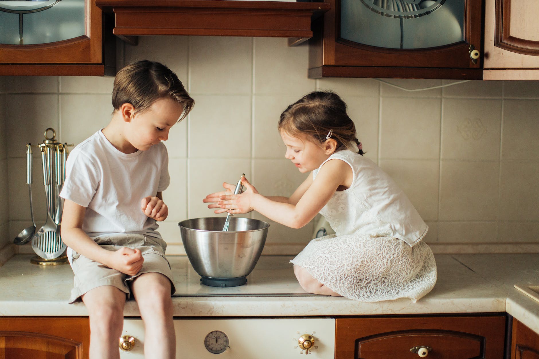 photo of kids playing in kitchen counter top